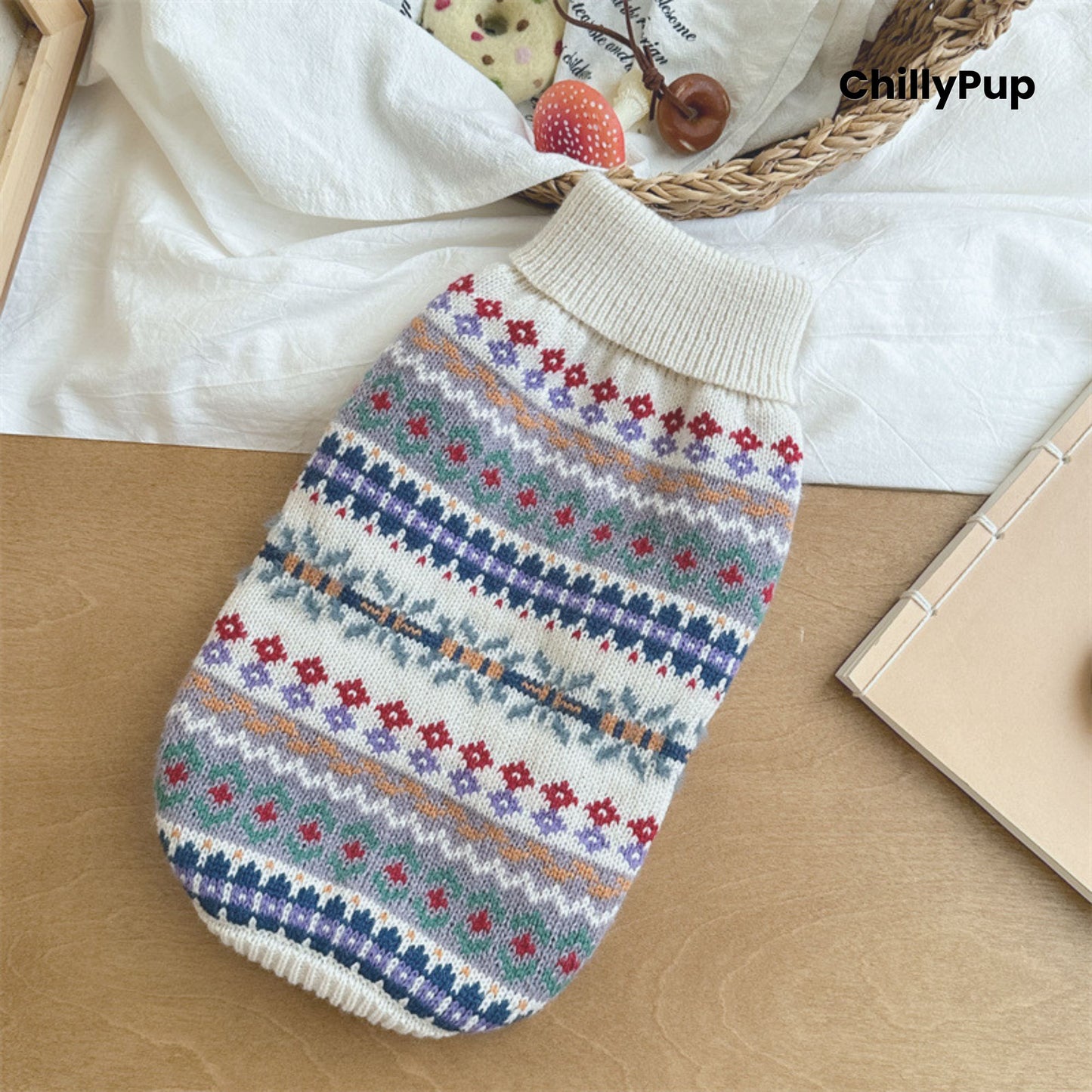 Knitted dog jumper with colourful pattern on a white surface, brand 'ChillyPup' visible.